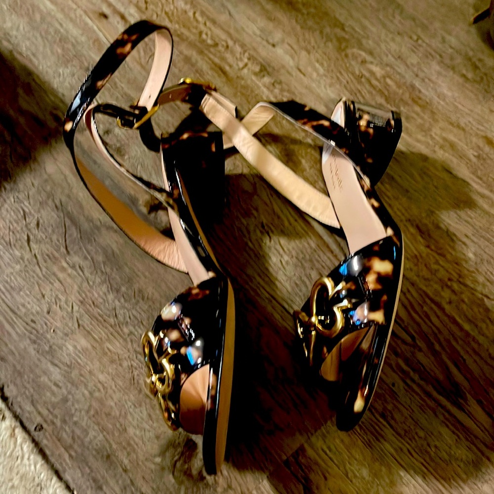 Kate Spade tortoise shell ankle strap sandals with a kitten heel.